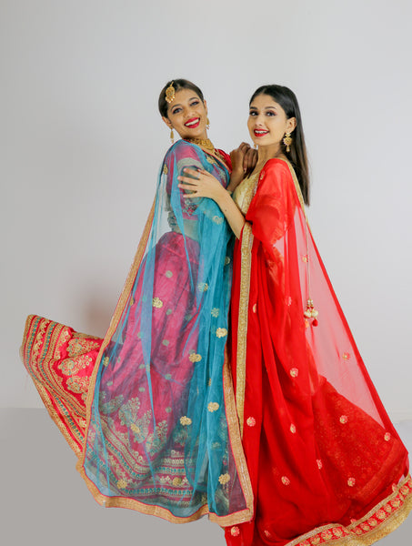 Models posing for party collection where customers can rent or buy sarees and lehengas